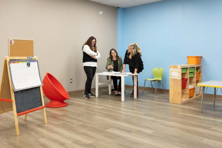 Clinicians setting up a session in a therapy room at AlphaBee’s Etobicoke centre